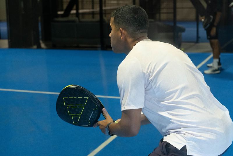 A player sets up a two-handed backhand from the back court