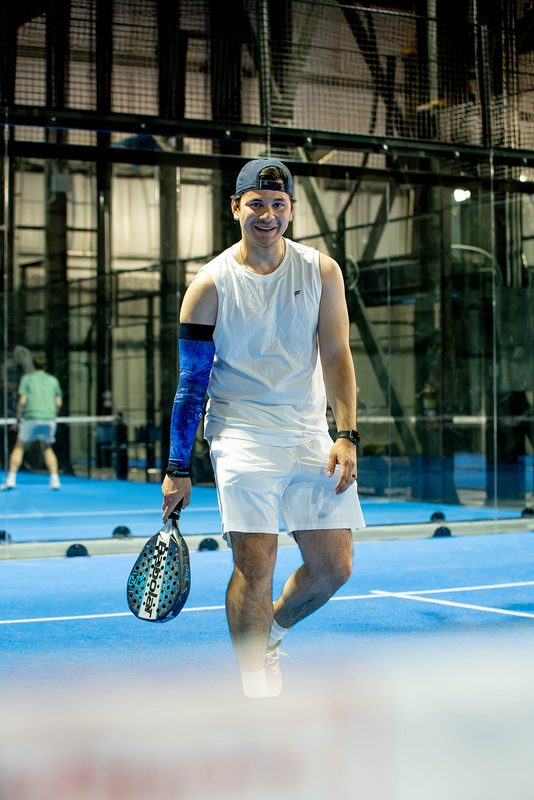 A player walks back to the baseline between points at Foundry Padel