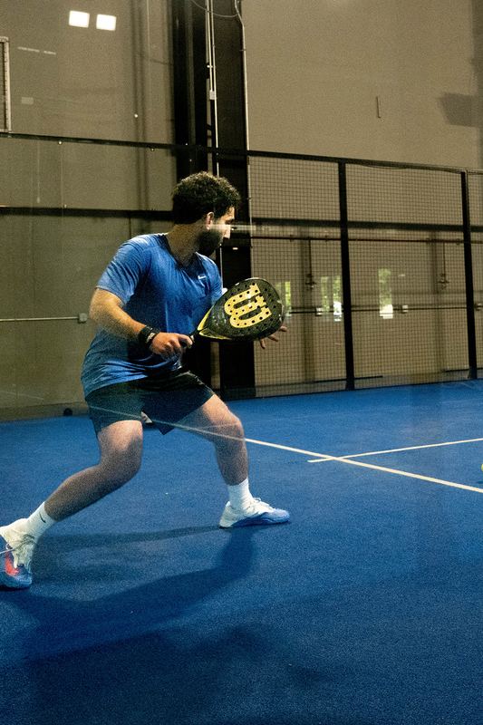 A player drives the ball crosscourt from the back of the court