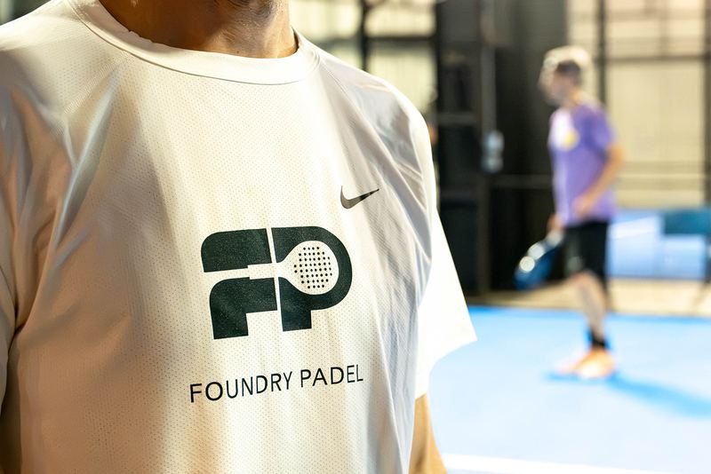 The Foundry Padel logo on a player's shirt courtside