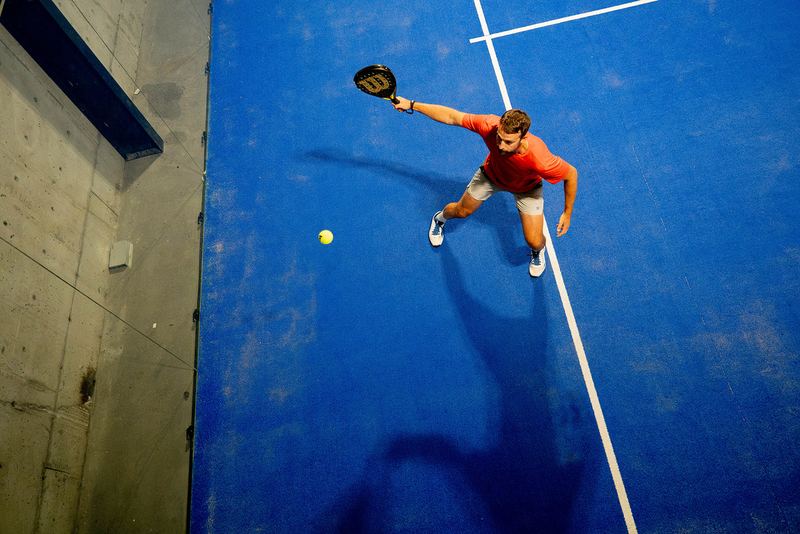 A player and their long shadow stretched across the court