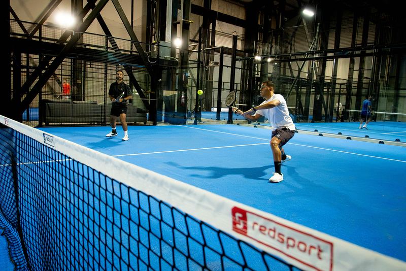 A rally seen from behind the net at Foundry Padel