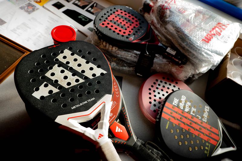 Padel racquets laid out on the pro shop counter at Foundry Padel