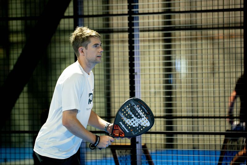 A player waits in the ready position at the net