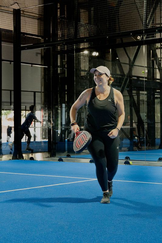 A player sprints to run down a drop shot